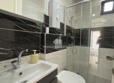 Элегантная квартира с одной спальней, 55м². в новостройке в районе вторничного рынка в Махмутларе, Алания ID-18957 фото-8