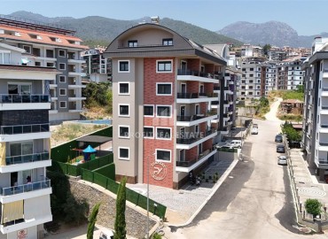 Трехкомнатные апартаменты с видом на море и горы, 68м², в малоквартирном комплексе в районе Алании - Оба ID-18986 фото-1