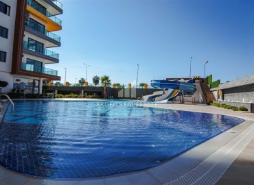 Видовая дизайнерская квартира 1+1, 55м², в элитном комплексе на первой береговой линии в Махмутларе, Алания ID-19032 фото-17