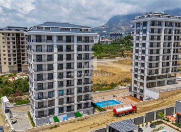 Двухкомнатные апартаменты, 50м², в новом комплексе премиум класса в центре Махмутлара, Алания ID-19047 фото-1