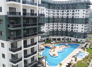 Элегантные трехкомнатные апартаменты, 100м², в элитном комплексе в Махмутларе, Алания ID-19074 фото-1