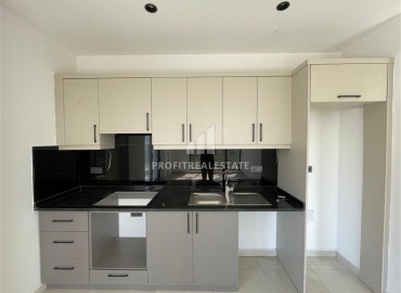 Комфортабельная квартира с одной спальней, 55м², в новостройке премиум класса в центре Махмутлара, Алания ID-19096 фото-4