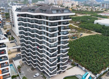 Комфортабельная квартира с одной спальней, 55м², в новостройке премиум класса в центре Махмутлара, Алания ID-19096 фото-12