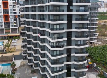 Комфортабельная квартира с одной спальней, 55м², в новостройке премиум класса в центре Махмутлара, Алания ID-19096 фото-13