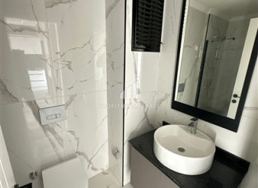 Двухкомнатные апартаменты, 55м², с чистовой отделкой в резиденции премиум класса в Махмутларе, Алания ID-19221 фото-11