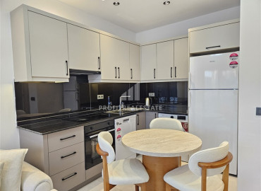 Дизайнерская квартира с одной спальней, 55м², в новостройке премиум класса в центре Махмутлара, Алания ID-19563 фото-5