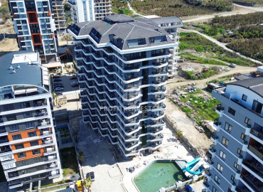 Дизайнерская квартира с одной спальней, 55м², в новостройке премиум класса в центре Махмутлара, Алания ID-19563 фото-15