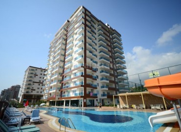 Трехкомнатные апартаменты в комплексе 2016 года постройки с крытым и открытым бассейном в курортном районе Махмутлар. ID-2041 фото-1