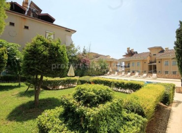 Двухуровневые апартаменты с выходом в сад в центре Алании ID-0073 фото-1